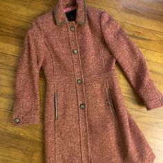 Wool Tweed Coat With Leather Trim In Really Good Used Condition. One Button Came Off, But Will Come With 3 Spares (Photo 3 Of Spare Button On Spot It Came Off). Burnt Orange And Pink Colors Throughout The Tweed Pattern. Tweed Pattern, Tweed Coat, Coach Jacket, Trim Color, Burnt Orange, Wool Coat, Leather Trims, Pink Color, Jackets & Coats