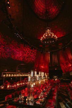 an elaborately decorated dining room with candles and chandeliers