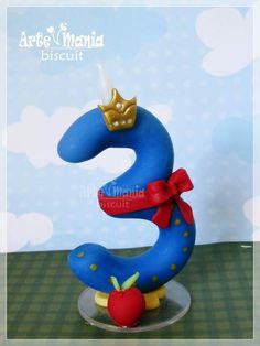 a cake shaped like the number three with a crown on top