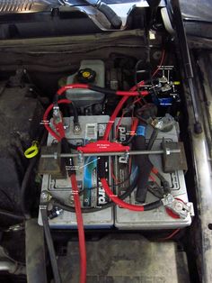 the engine compartment of a car with wires connected to it