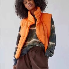 Urban Outfitters Corrine Puffer Vest Bright Orange Sz M Nwt The Essential Corrine Puffer Vest In A Range Of Colors We Love. Modern Boxy Silhouette With A Zip Front And Oversized Collar That Stands Up Or Folds Down. Loose Fit With A Snap-Covered Zip Front. Finished With Front Pockets. 100% Polyester Casual Winter Vest Outerwear, Casual Winter Vest, Casual Cold Weather Outerwear Vest, Spring Outdoor Puffer Vest, Urban Outfitters Cotton Outerwear For Fall, Winter Orange Sleeveless Vest, Casual Spring Vest Outerwear, Orange Sleeveless Winter Vest, Casual Solid Vest For Cold Weather