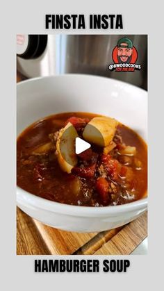 a white bowl filled with soup on top of a wooden cutting board