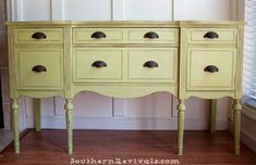 an old yellow dresser with drawers and knobs