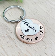 two personalized metal key chains with the words,'love is always in my heart '