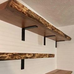 three wooden shelves with metal brackets on them