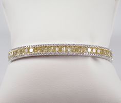 14K White Gold Canary Yellow Diamond Bangle Bracelet. This bracelet is set with twenty-five genuine Canary Yellow Cushion Cut Diamonds and one hundred and twenty (120) natural Round Brilliant Colorless Diamonds. The Canary Diamonds are sparkly and brilliant, are SI1 clarity and weigh a total of 6.35 carats.  The colorless round diamonds are G/H color, SI clarity and weigh a total of .78 carats. The total diamond weight of this bracelet is 7.13 carats.  This bracelet is solid 14K White Gold, weig Cheap Yellow Bangle Bracelet, Luxury Dazzling Yellow Gold Diamond Bracelet, Yellow Diamond Bracelet, Yellow Gemstone Jewelry, Canary Yellow Diamonds, Wedding Jewellery Designs, Canary Diamond, Yellow Cushion, Diamond Bangle Bracelet