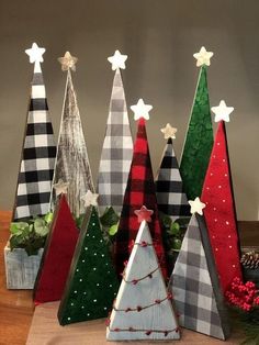 christmas trees made out of wood are sitting on a table