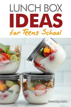 four glass containers filled with fruit and yogurt