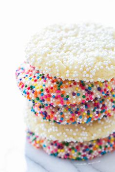 a stack of sprinkle covered cookies sitting on top of each other