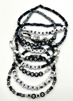 Beaded bracelets based on the album Mono by RM of BTS. Each bracelet features a song title from the album. Mix and Match to create your perfect combination. Please keep in mind that colors may appear different due to individual screen settings. Trendy Black Name Bracelet With Round Beads, Kpop Style Friendship Bracelets With Round Beads, Trendy Black Beaded Name Bracelet, Adjustable Kpop Bracelets With Letter Beads, Adjustable Kpop Letter Beads Bracelets, Adjustable Kpop Bracelet With Letter Beads, White Beaded Bracelets With Letter Beads Kpop Style, White Kpop Beaded Bracelets With Letter Beads, White Letter Beads Bracelet Kpop Style