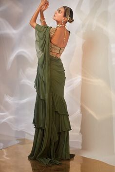 Green pre-draped saree with ruffle border. Paired with sequin applique, cutdana embroidered padded blouse and belt. - Aza Fashions Fitted Sleeveless Saree With Ruffles, Green Georgette Saree With Ruffles, Fitted Green Pre-draped Saree With Ruffles, Saree Gowns, Classic Saree, Dhoti Saree, Cotton Sarees Handloom, Wedding Guest Attire, Ruffle Sarees