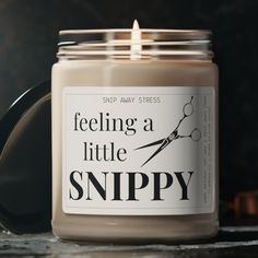 a candle that is sitting on a table with scissors in front of it and the words, feeling a little snipy