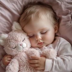 a baby sleeping with a teddy bear