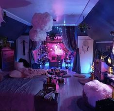 a bedroom decorated in pink and purple with lots of lights on the ceiling, furniture and decorations