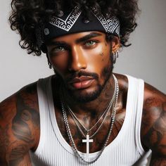 a man with tattoos and piercings on his face wearing a cross necklace, white tank top