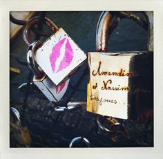 two padlocks attached to each other with pink lipstick on them and the words underneath it