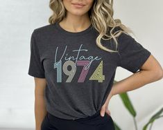 1974 Vintage Shirt, 1974 Birthday Shirt, 1974 Vintage Tee,50th Birthday Gift, 50th Birthday Gift Shirt,1974 Retro Shirt,Retro 1974 Tee Shirt fathers day giftRetro Birthday Tee50th Birthday Shirt50th Birthday Tee50th Birthday PartVintage 1974 Shirt1974 Vintage Shirt1974 Shirt 1974Born In 1974 Tee1974 Shirt For Mom1974 Shirt For Wife1974 Gift Tee1974 T-Shirt Premium Quality Printed in the USA.  We sell Mrotto and Bella Canvas brands for our Youth, Toddler and Unisex T-shirts, with the same high qu Retro Short Sleeve Top For Birthday, Retro Graphic Print Tops For Anniversary, Retro Letter Print Tops For Birthday, Retro Summer Tops For Anniversary, 1974 Birthday, 50th Birthday Shirts, Retro Birthday, Birthday Tee, 50th Birthday Gifts