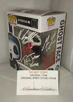 the box is open and has some autographed items on it, including an alien head