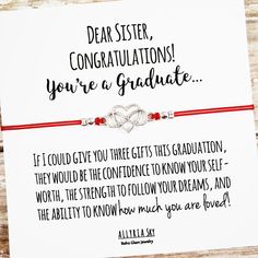 a red string bracelet with two intertwined hearts on it that says, dear sister congratulations you're a graduate