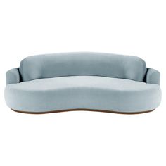 an oval shaped couch in blue velvet