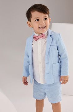 Your little one will impress the grownups in this dapper suit set that comes with a button-up shirt, a two-button blazer and tailored shorts. Shirt has front button closure Blazer has two-button closure; front flap pockets Shorts have button closure with back elastic waist; faux fly; front slant pockets; back welt pockets Blazer is lined Shirt is 100% cotton; blazer and shorts are 55% linen, 45% cotton, 4% elastane; bow tie is 100% polyester Machine wash, tumble dry Imported Dapper Suits, Blazer Set, Tailored Shorts, Blazer Shirt, Blazer And Shorts, Short Suit, Boys Jacket, Linen Blazer, Formal Looks