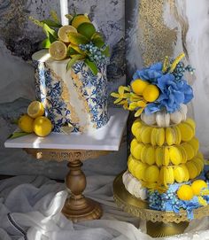 two tiered cakes decorated with lemons and blue flowers