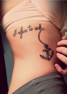 a woman's stomach with an anchor tattoo on it