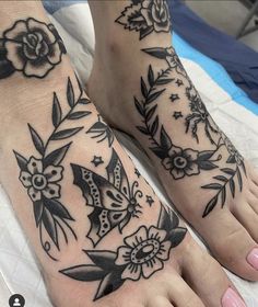 two feet with black and white tattoos on them, one is decorated with leaves and flowers