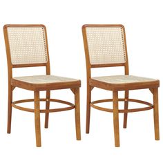 two wooden chairs with wicker backrests on each one and the other side