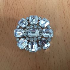 Vintage Emerald Cut Clear Rhinestone Brooch on Silver Tone Setting. This stunning pin will make a beautiful gift. Measures 1 4/8 inches in diameter. Has a rollover safety clasp. Very good condition. Please see photos. 2022-04 Round Rhinestone Brooches For Formal Occasions, Round Formal Brooches With Rhinestones, Formal Round Brooches With Rhinestones, Formal Round Rhinestone Brooches, Crystal Round Brooch For Party, Round Crystal Brooch For Party, Wedding Brooches With Rhinestones, Anniversary Rhinestone Round Brooches, Anniversary Brooches With Rhinestones