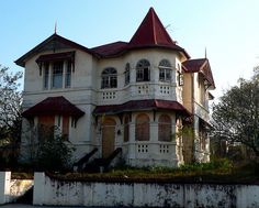 an old victorian style house with red roof