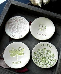 four personalized plates in a wooden box with flowers and dragonflies on the plates