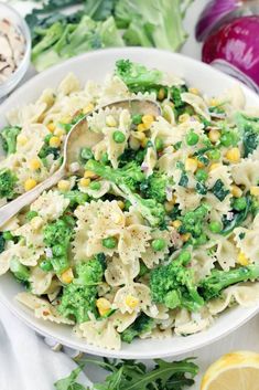 a white bowl filled with pasta and vegetables