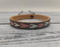 This bracelet is hand painted with leather paints.     * 100% Handmade    * Vegetable tanned leather    * Hand tooled    * Hand painted    * Adjustable Leather Bangle, Leather Wristbands, Leather Paint, Band Bracelet, Gift For Girlfriend, Vegetable Tanned Leather, Leather Band, Girlfriend Gifts, Cuff Bracelets