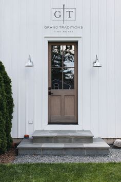 the front entrance to grand traditionals fine homes, with steps leading up to it