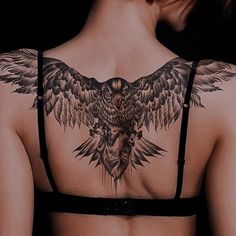 the back of a woman's bra with an owl tattoo on it