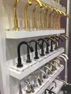 a row of sink faucets on display in a store