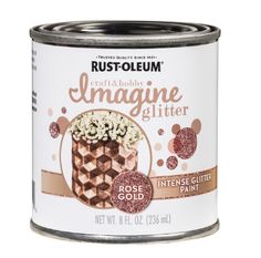 an open can of gold glitter paint with white and brown designs on the side,