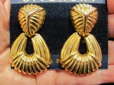 "Vintage GIVENCHY Large Gold Tone Art Deco Dangle Drop Door Knocker Runway Couture Clip Earrings This are stunning vintage GIVENCHY earrings. Still on the original card. The earrings feature a ribbed gold tone Mercedes emblem on the top portion and a ribbed door knocker lower section. They measure 2\" long x 1\" wide. Very sturdy and well made. They are definitely Givenchy, but I cannot find the logo on the backs, I think maybe the clips were changed. I am selling them at a very low price, for v Mercedes Emblem, Givenchy Earrings, Tone Art, Vintage Givenchy, High Fashion Women, French Luxury, Door Knocker, Original Card, Clip Earrings