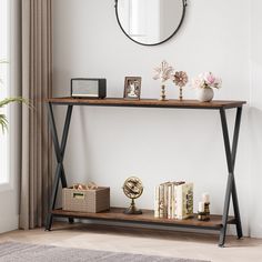 a shelf with books and other items on it in front of a mirror, clock and window