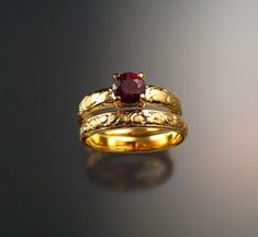 This is a beautiful Raspberry Rhodolite Garnet. The 6 mm stone is eye clean and set in 14k Yellow Gold with 4mm wide shank in a vintage style floral pattern. Garnet rates a 7 on the Mohs scale for hardness. Comes with matching 3mm band. I can make this ring for you in any size between 4 and 10 1/2. Specify your size at check-out. Lesbian Engagement Ring, Engament Rings, Garnet Wedding, Rhodolite Garnet Ring, Arte Robot, Gold Rings Fashion, Sapphire Wedding, Garnet Ring, Rhodolite Garnet