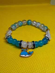 White & Blue beads with gold accents and blue whale charm 7 in or 17.78 cm ale  SMALL BEADS Strong, Stretchy, and Durable     Very pretty bracelet for any occasion for any day Casual Blue Charm Bracelet With Round Beads, Chesapeake Va, Small Beads, Blue Whale, Pretty Bracelets, Blue Beads, Gold Accents, Arm Band, White Blue