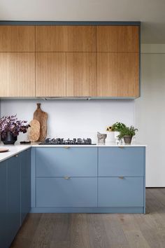 a kitchen with blue cabinets and white counter tops is pictured in this image from the front view