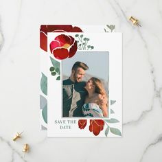 an image of a wedding save the date card with red flowers and leaves on it