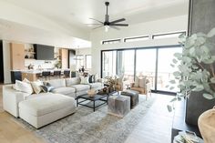 a living room filled with furniture and a large open floor plan that has sliding glass doors