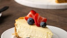 a slice of cheesecake with berries on top