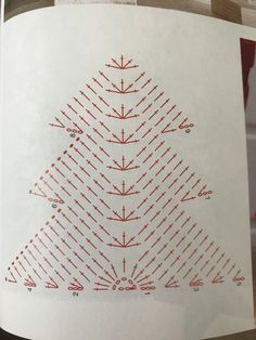 a white paper with red dots on it and a triangle in the middle that has been cut out