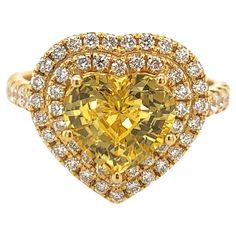 Elegant heart shape yellow sapphire ring. Hi brilliance, transparent clean, golden yellow tone, heart shape, unheated yellow sapphire mounted in high profile with five bead prongs, accented with two rows of round brilliant cut diamonds. Handcrafted heart shape classic design set in 14 karats yellow gold. Ideal for weddings and engagements! Yellow Sapphire: 3.19 carats, unheated, hi brilliance, golden yellow tone Diamond: 0.70 carat, round brilliant cut Color: G-H Clarity: Dimensions: 14mm x 14mm Yellow Sapphire Ring, Yellow Sapphire Rings, Yellow Tone, Heart Shaped Rings, Yellow Tones, Yellow Sapphire, Golden Yellow, Round Brilliant Cut Diamond, Cut And Color