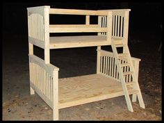 a wooden bunk bed sitting on top of a dirt field