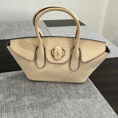 Beautiful Used Good Condition Bag Beige Top Handle Satchel With Dust Bag, Designer Beige Handheld Satchel, Beige Leather Handheld Satchel, Designer Cream Satchel Bag, Handheld Beige Leather Satchel, Designer Cream Tote Satchel, Cream Leather Handheld Shoulder Bag, Cream Leather Satchel With Top Carry Handle, Cream Leather Shoulder Bag With Top Carry Handle